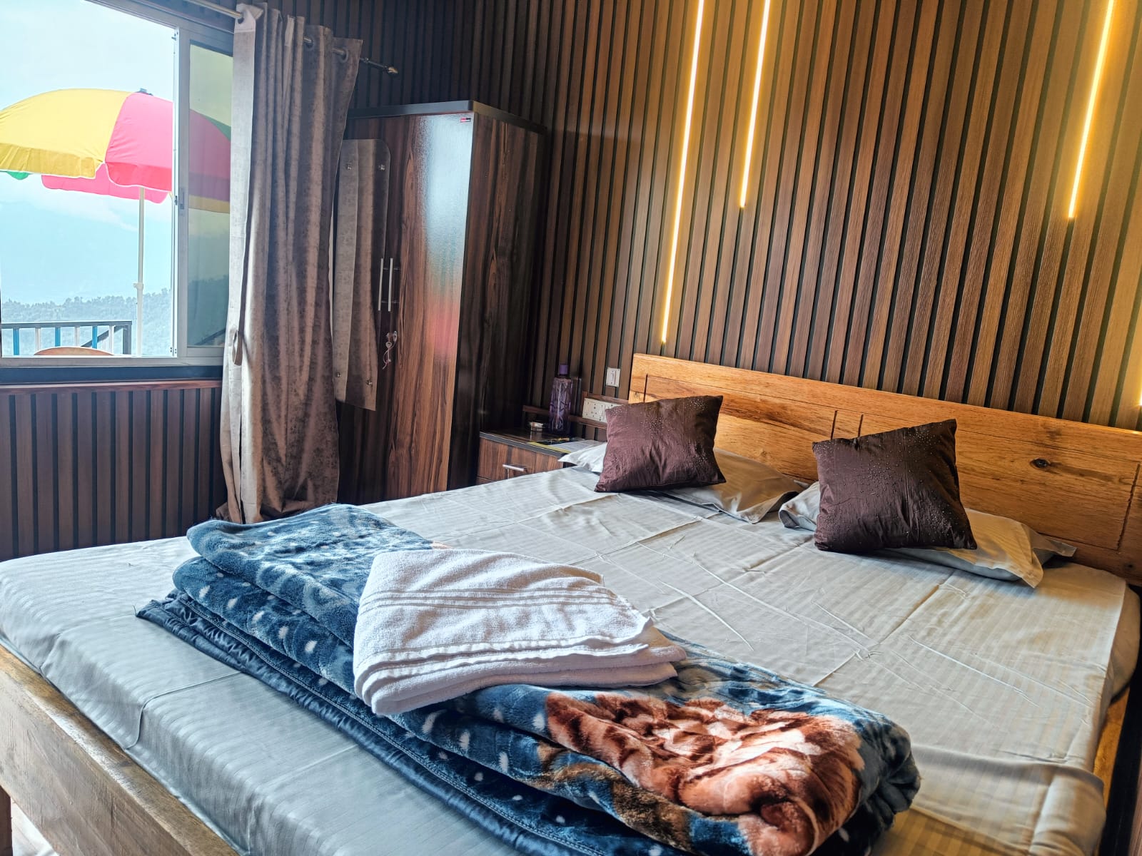 Guest bedroom with a double bed and wood panelled wall