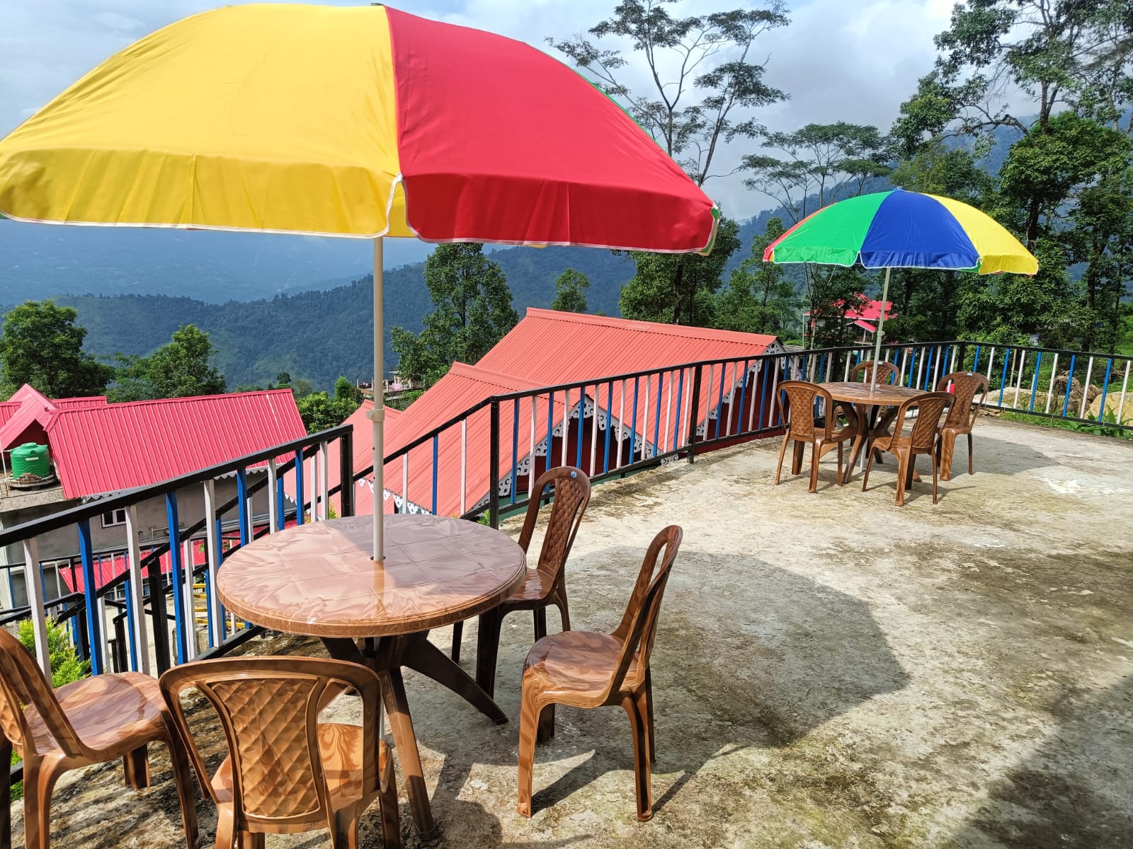 Outdoor terrace with tables and colourful umbrellas